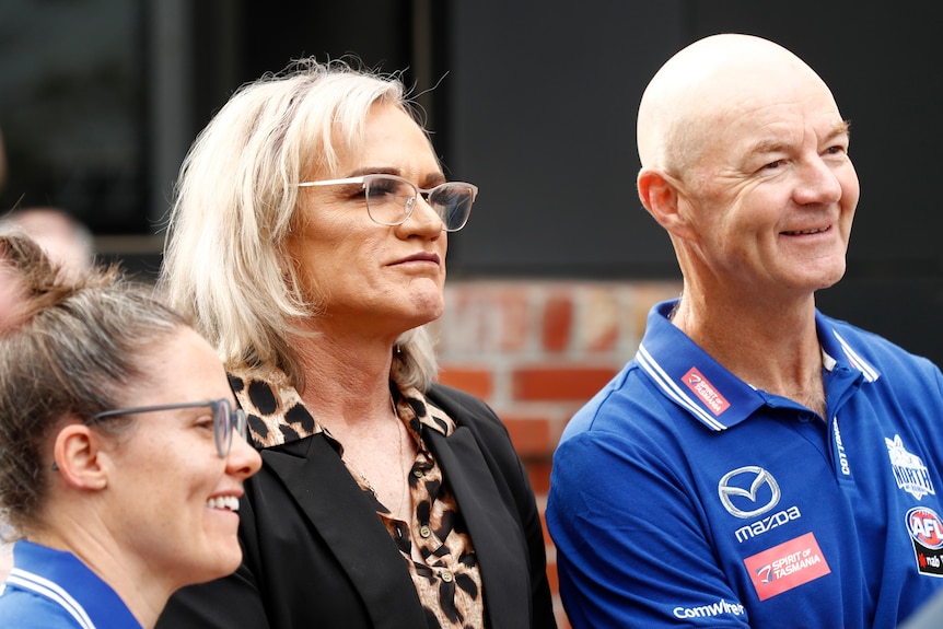 Dani Laidely and Darren Crocker look on during an outdoor event