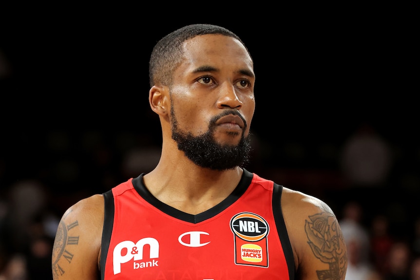A head and shoulders shot of Bryce Cotton wearing his red Perth Wildcats uniform during an NBL game.