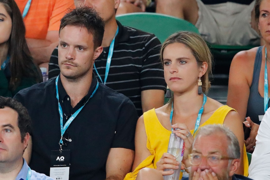 Mitch Brown sitting with wife and Collingwood netball player Shae Brown at the Australian Open.