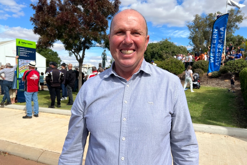 A man smiles at the camera. 