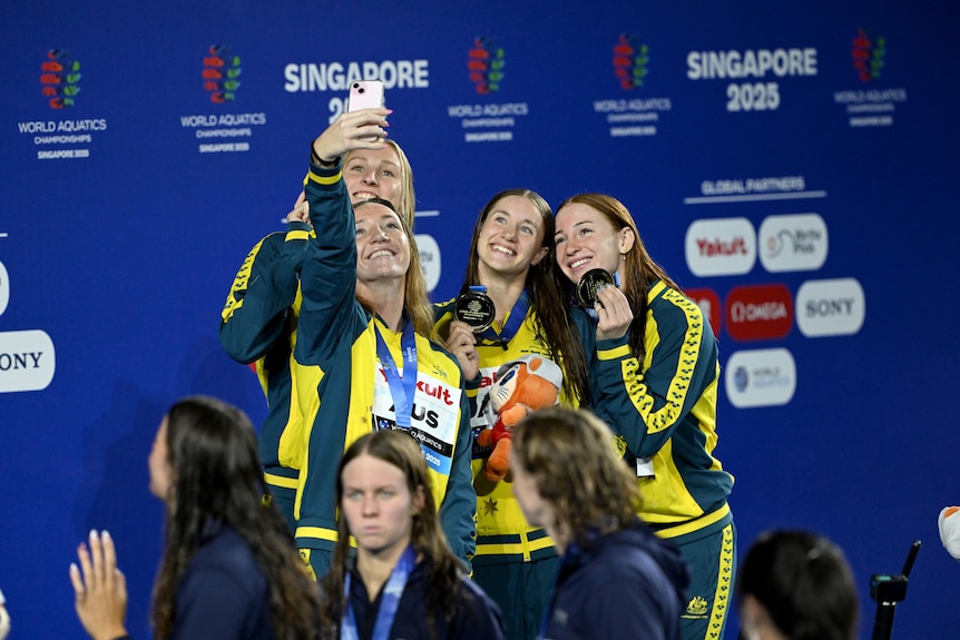 Lani Pallister, Jamie Perkins, Brittany Castelluzzo and Mollie O'Callaghan celebrate with their world championship gold medals.