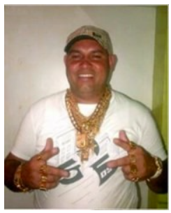 A person wearing a hat and gold chain AI-generated content may be incorrect.