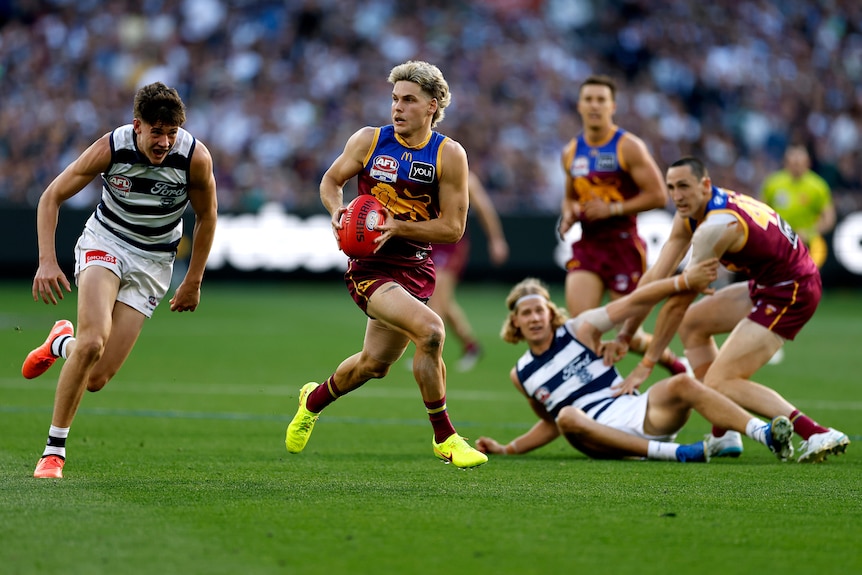 Will Ashcroft of the Lions runs with the ball.