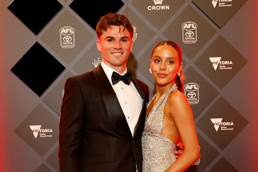 Ben Keays from the Adelaide Crows arrives with his partner Rose Konstantinou in a sparkly halter neck dress. 
