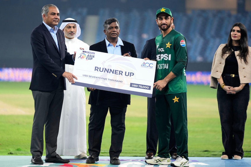 A player recieves a runner up award for his team during a ceremony