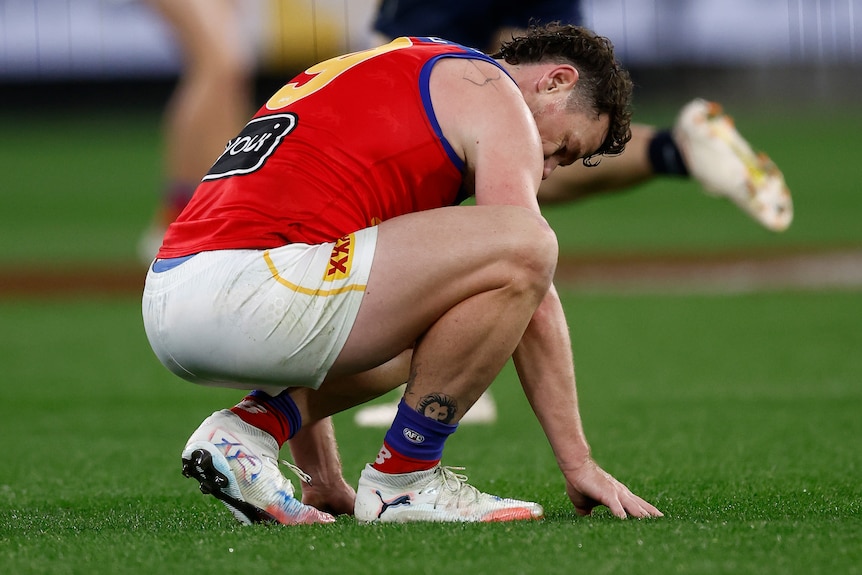 A man slumps to the ground during a rugby league match