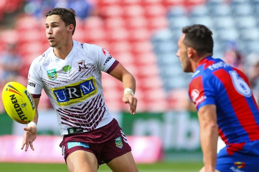 A man looks to pass during a rugby league match