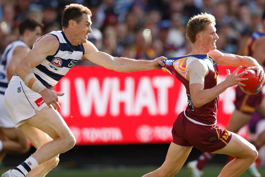 Jeremy Cameron grabs Jaspa Fletcher by the guernsey.
