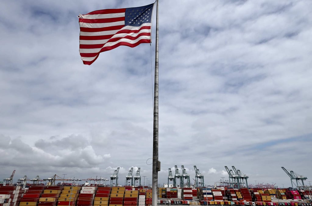 An American flag flies in front of shipping containers and cranes at the Port of Los Angeles last week in the California city. Photo: AFP An American flag flies in front of shipping containers and cranes at the Port of Los Angeles last week in the California city. Photo: AFP