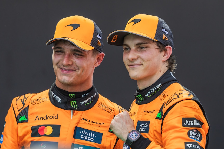 Lando Norris and Oscar Piastri pose for a photograph, Piastri (right) with his fist clinched