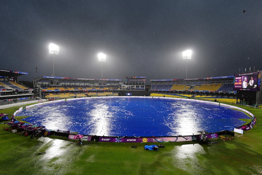 A general view of R Premadasa Stadium in Colombo with the covers on while raining.