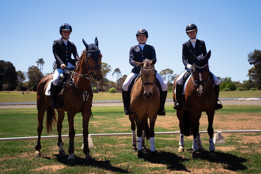 Three equestrians sit on their horses at the Toowoomba Showgrounds