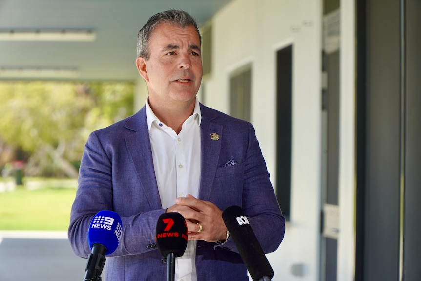 City of Stirling Mayor Mark Irwin speaks in front of microphones.