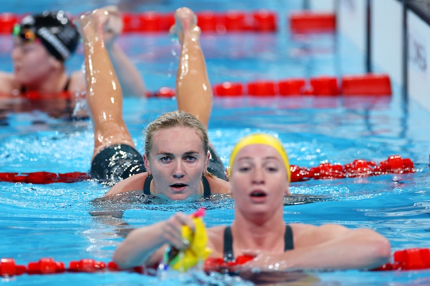 Ariarne Titmus looks at Mollie O'Callaghan as she rolls over a lane rope