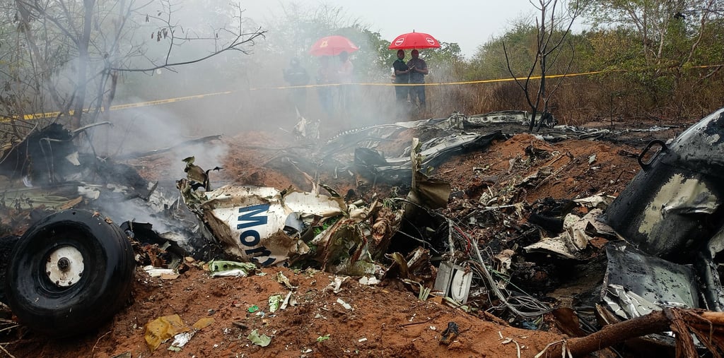 Kenyan officials inspect the scene of the plane crash near Diani, Kenya, on Tuesday. Photo: AP