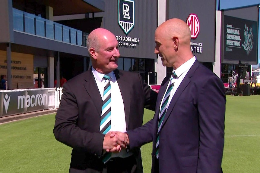 David Koch and Warren Tredrea shake hands.