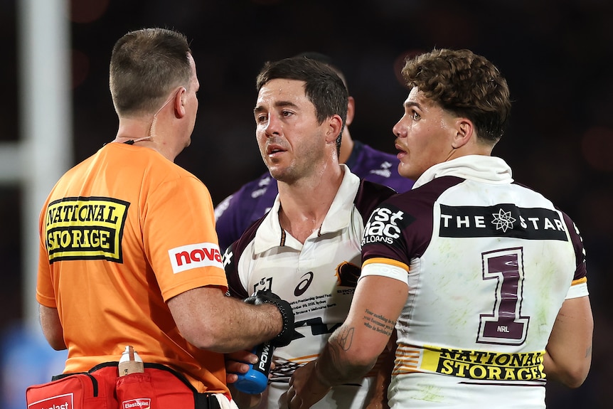 Ben Hunt is checked by trainers during the NRL grand final.