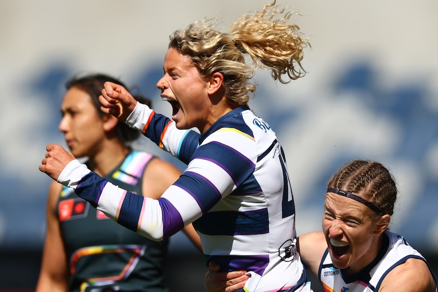 Georgie Prespakis celebrates an AFLW goal with a Cats teammate against the Giants.