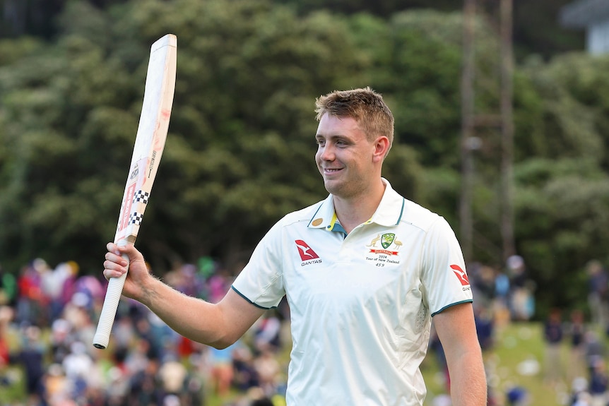 Cameron Green holds up his bat