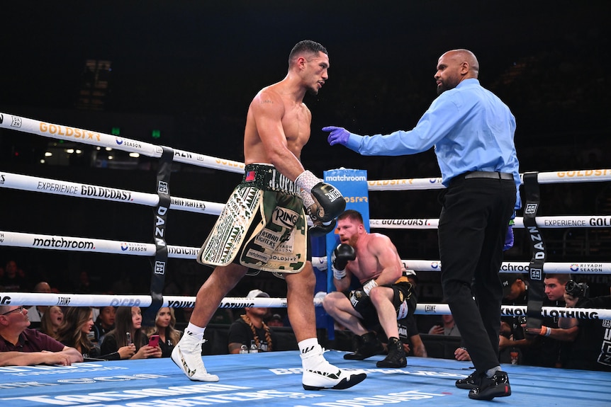 Jai Opetaia walks away from a man in the corner of the ring