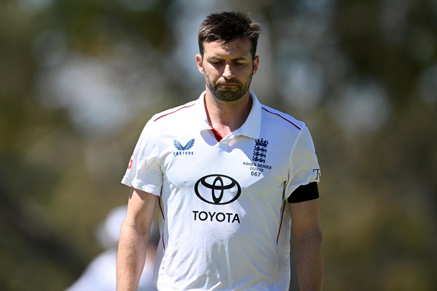 Mark Wood looks sad during an England warm-up match.