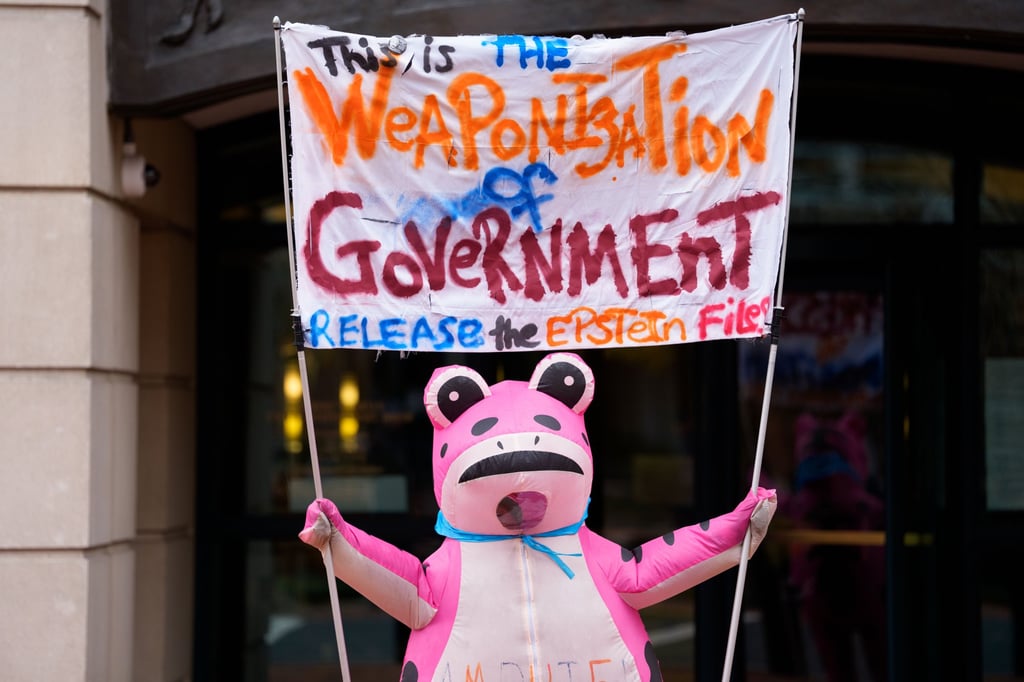 A protester demonstrates outside court during a motion hearing for former FBI director James Comey in Alexandria, Virginia, on Wednesday. Photo: EPA A protester demonstrates outside court during a motion hearing for former FBI director James Comey in Alexandria, Virginia, on Wednesday. Photo: EPA