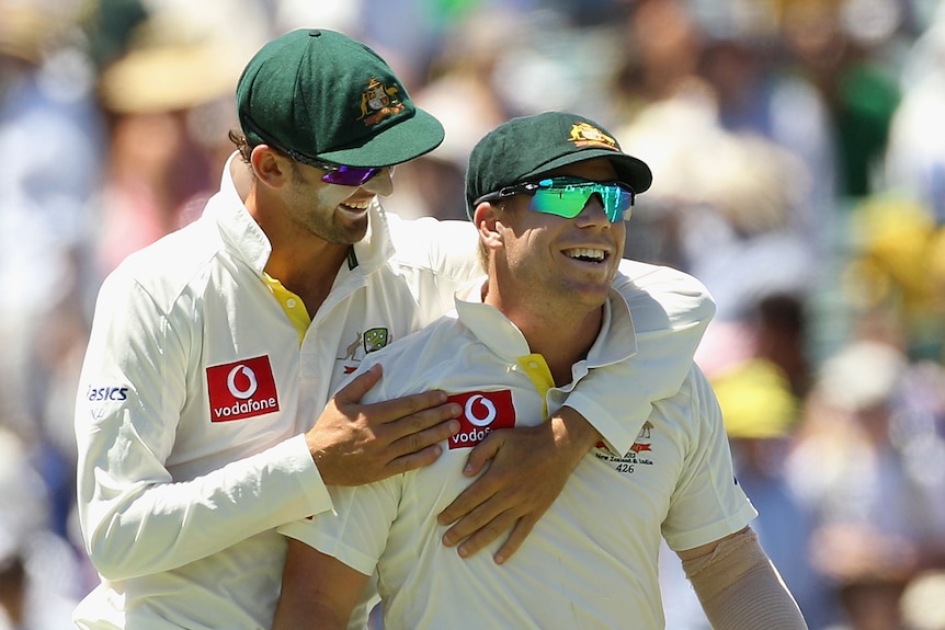 Nathan Lyon hugs David Warner during a Test in 2012.