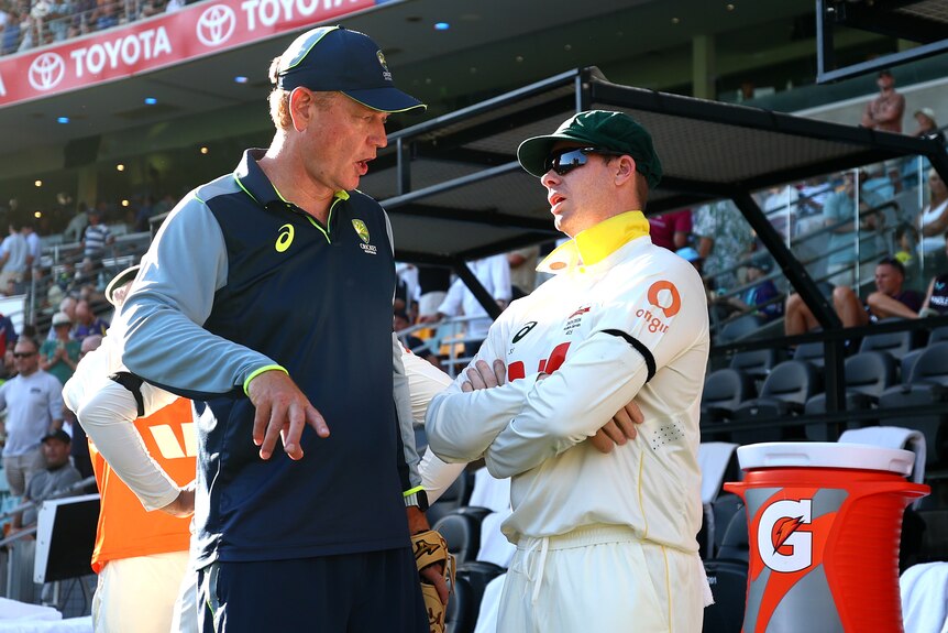 Australia coach Andrew McDonald speaks to captain Steve Smith on the sidelines of the second Test at the Gabba.