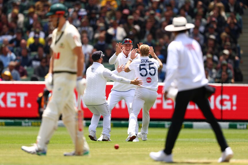 Ben Stokes and Zak Crawley high five after an Ashes wicket against Australia.