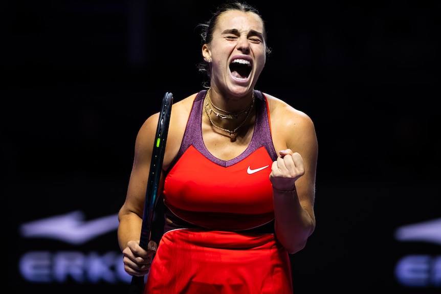 Aryna Sabalenka screams out as she celebrates winning a point at WTA Finals.