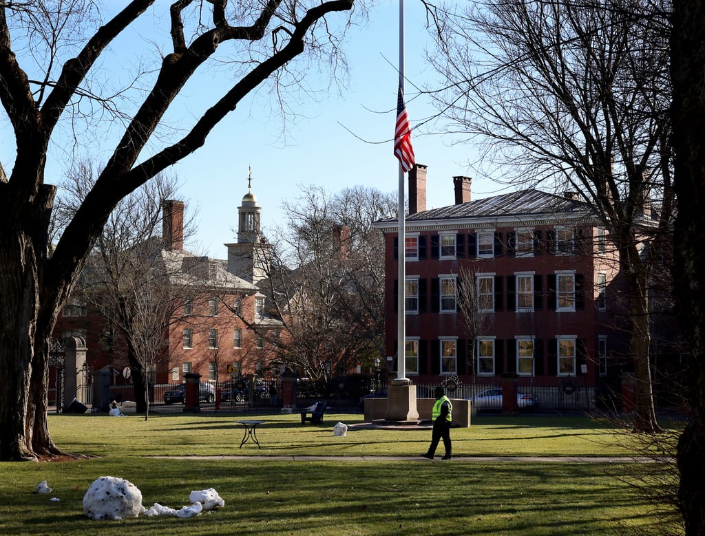 A security guard walks past a flag at half-staff on the main green of Brown University in Providence, Rhode Island, on Thursday. Photo: AP A security guard walks past a flag at half-staff on the main green of Brown University in Providence, Rhode Island, on Thursday. Photo: AP