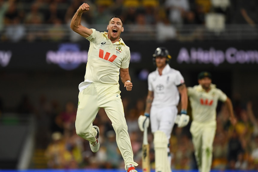 Scott Boland celebrates a wicket while an England batter looks disappointed behind him