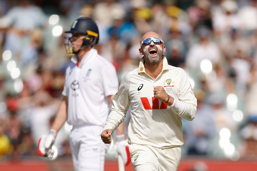Australia bowler Nathan Lyon, wearing sunglasses, shouts to celebrate a wicket in an Ashes Test.