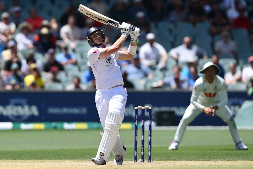 England batter Jamie Smith watches the ball fly away off his top edge.