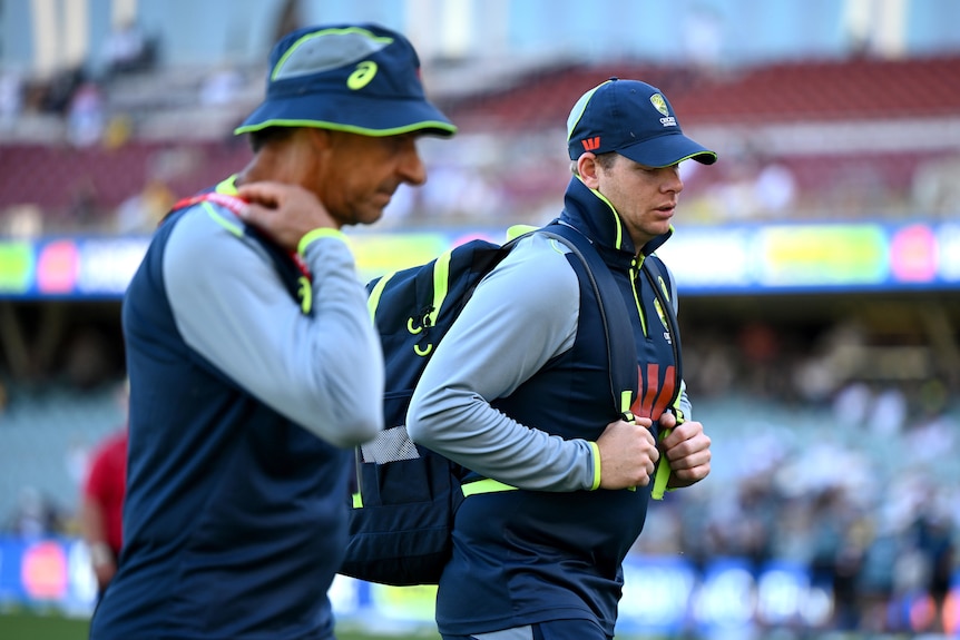 Australia batter Steve Smith walks off the Adelaide Oval with Australian team security.
