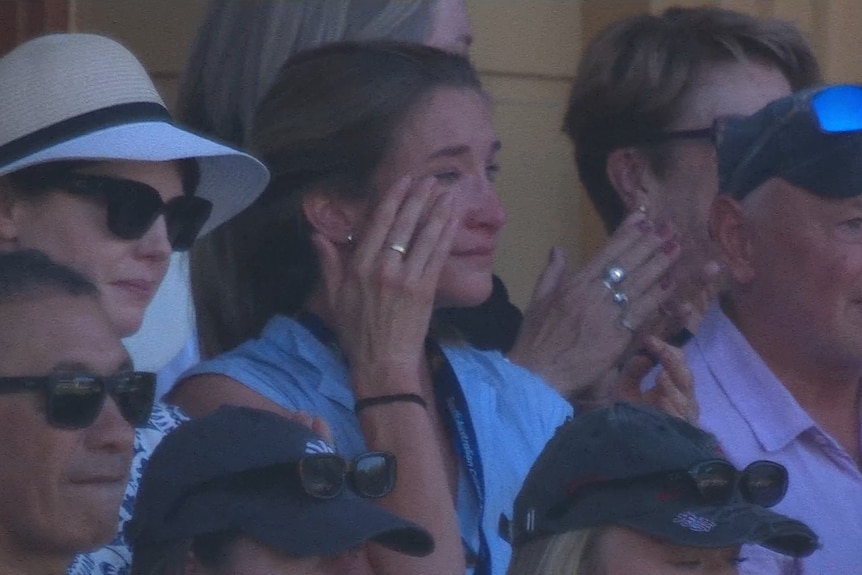 Eloise Carey wipes away a tear in the stands during an Ashes Test at the Adelaide Oval.
