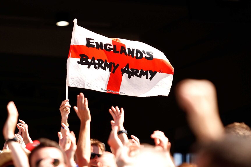 Barmy Army's white flag with red cross held in the crowd.