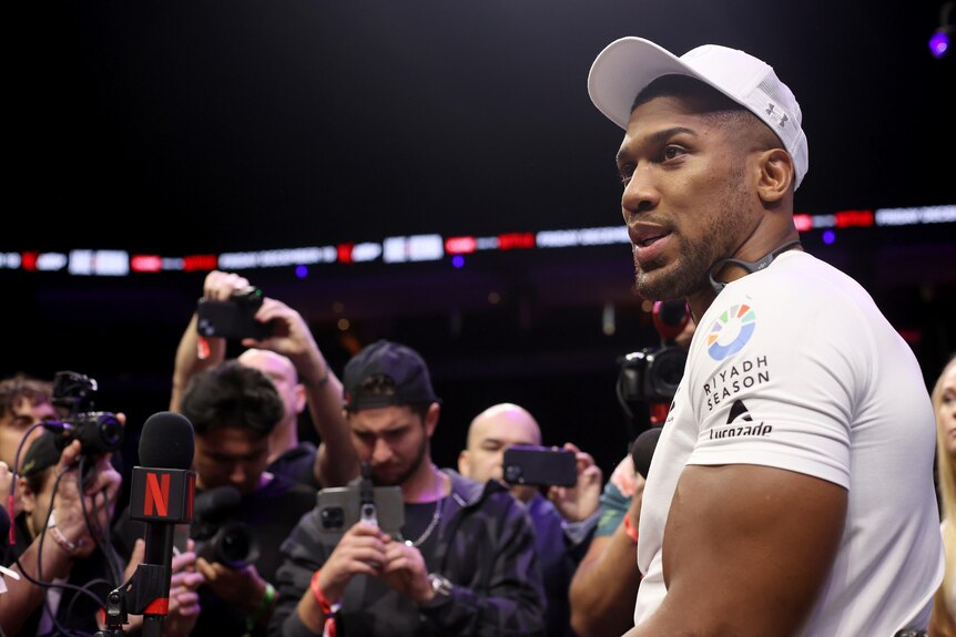 Anthony Joshua talks to media