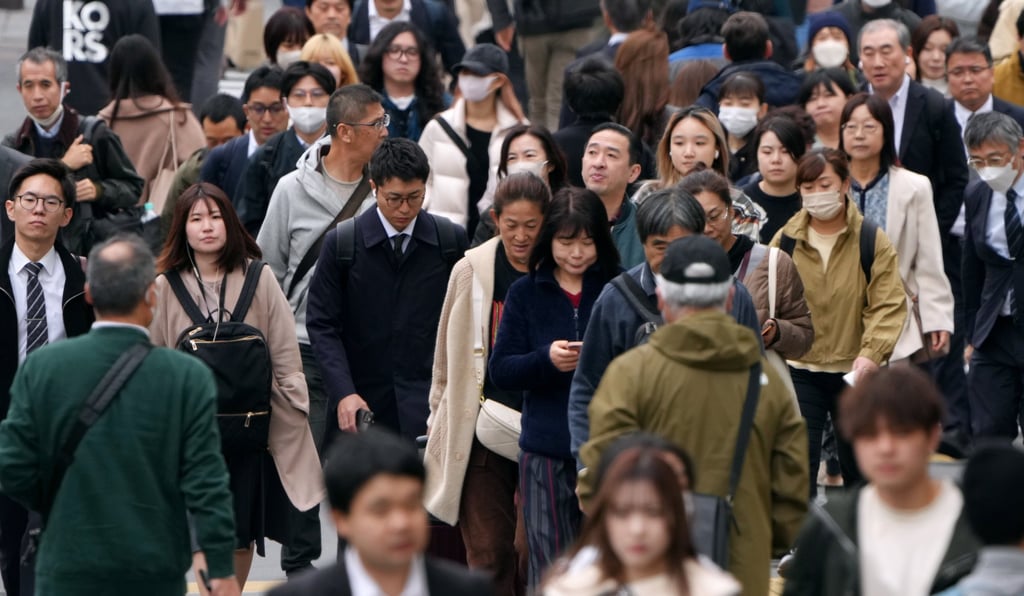 Commuters walk along Shinjuku Street in Tokyo. Photo: EPA-EFE Commuters walk along Shinjuku Street in Tokyo. Photo: EPA-EFE