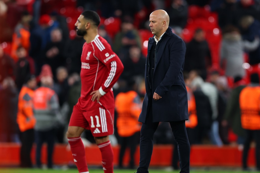 Arne Slot walks alongside Mohamed Salah
