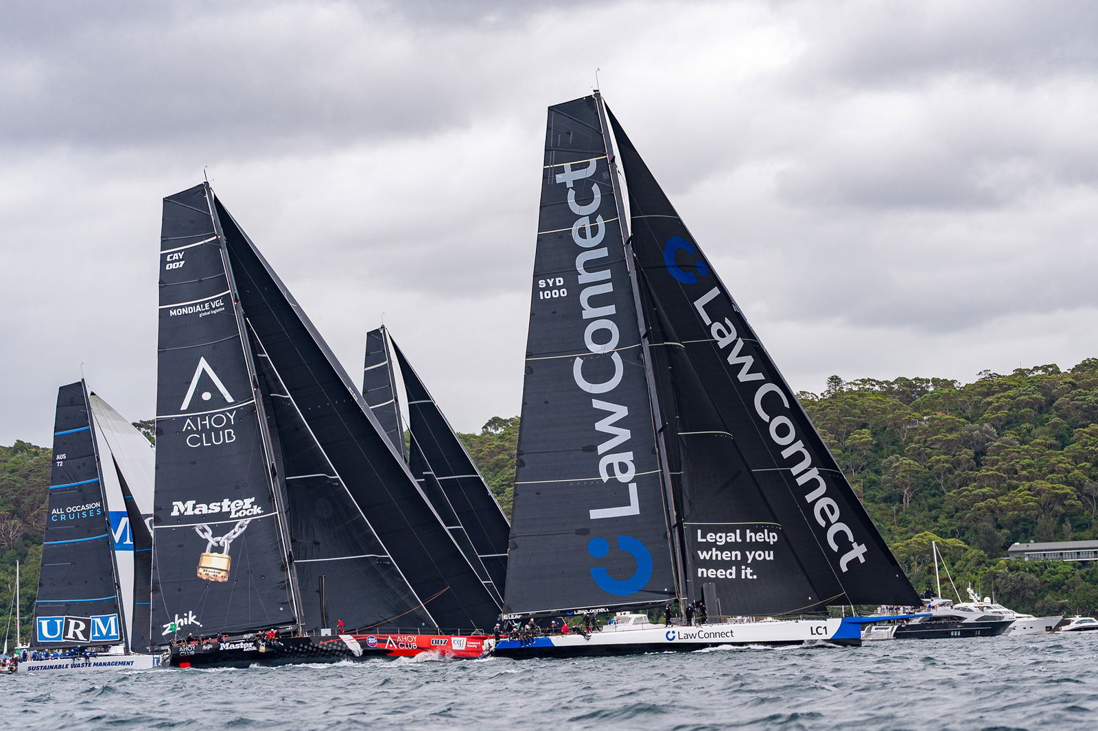Master Lock Comanche (L) and LawConnect lead the race during the 2025 Sydney to Hobart on Sydney Harbour on December 26, 2025 in Sydney, Australia.