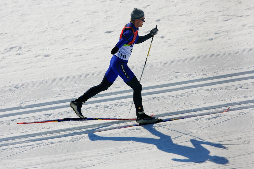 James Millar is striding across the snow on skis.