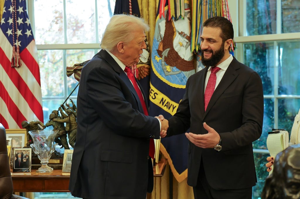 US President Donald Trump (left) shakes hands with Syria’s President Ahmad al-Sharaa at the White House in November. Photo: Syrian Presidency press office via AP