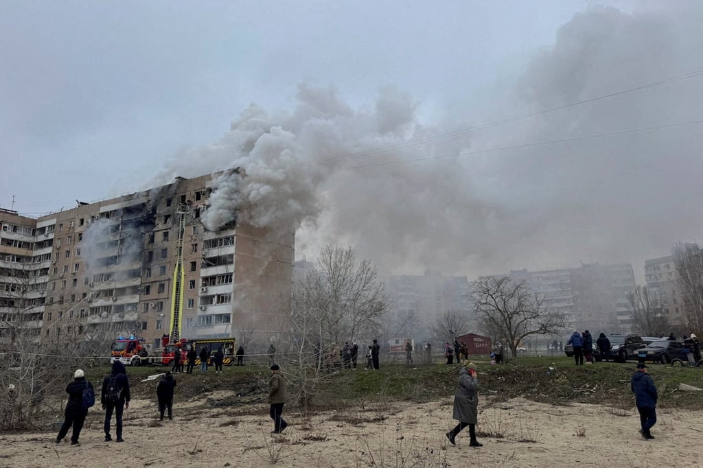 Residents walk in front of an apartment building hit by a Russian air strike in Zaporizhzhia, Ukraine, on Wednesday. Photo: Reuters
