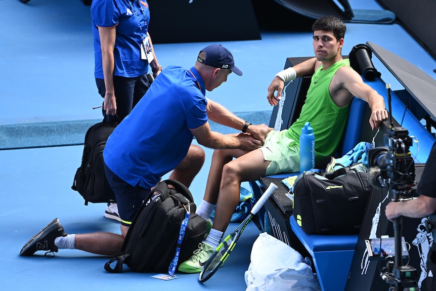 Carlos Alcaraz gets treatment at the Australian Open