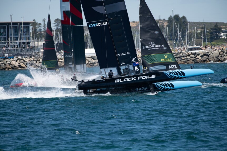 Boats racing with spray shooting up from the water.