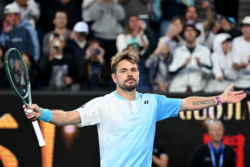 Stan Wawrinka with his arms out wide after he won