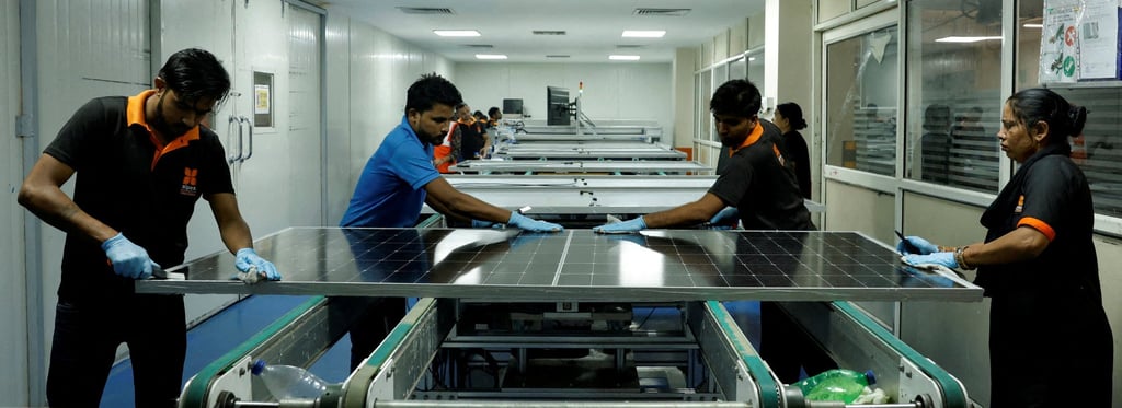 Technicians work on a solar panel in Greater Noida, on the outskirts of New Delhi. Photo: Reuters Technicians work on a solar panel in Greater Noida, on the outskirts of New Delhi. Photo: Reuters