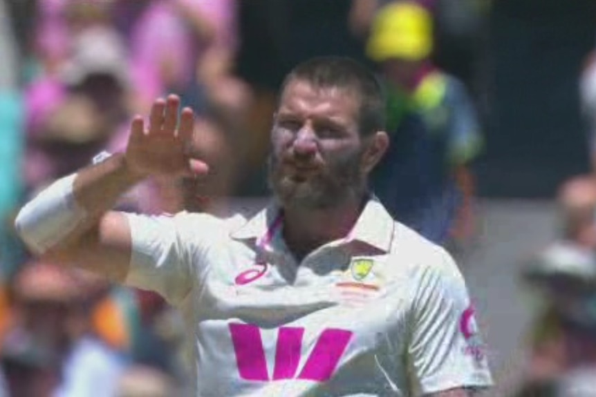Michael Neser waves his right hand