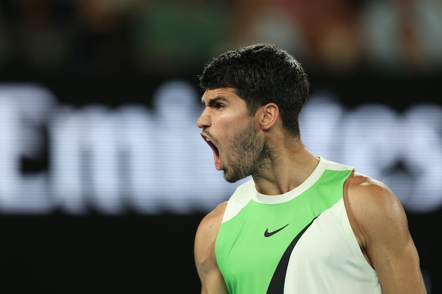 Carlos Alcaraz roars in celebration of a point